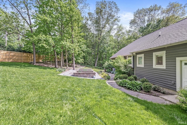 view of yard featuring an outdoor fire pit