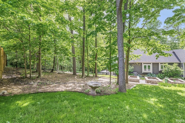 view of green lawn featuring a vegetable garden