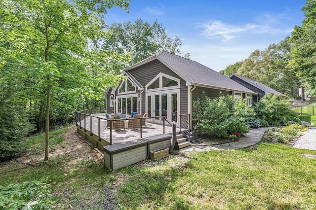 rear view of house with a wooden deck, a yard, roof with shingles, and outdoor lounge area