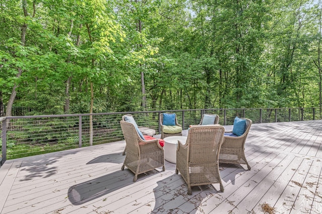 wooden deck with a view of trees