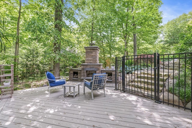 wooden deck featuring an outdoor living space with a fireplace