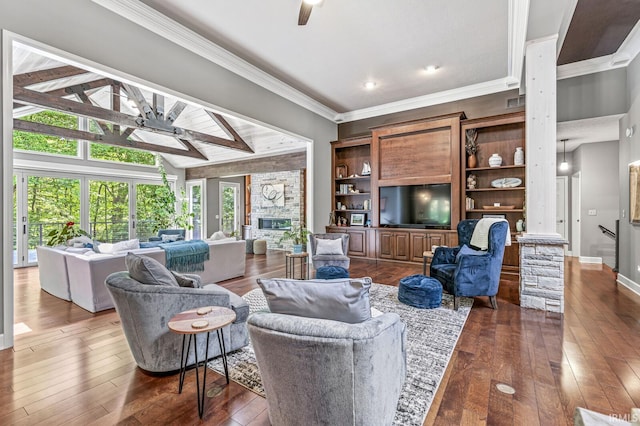 living area with a ceiling fan, dark wood-type flooring, baseboards, ornamental molding, and a fireplace