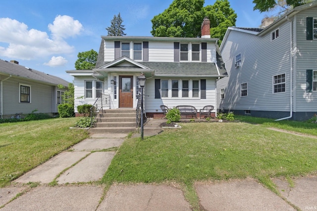 view of front of home featuring a front yard, a chimney, and roof with shingles