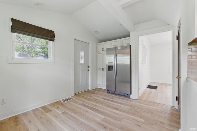 entrance foyer with lofted ceiling, light wood-style floors, and baseboards