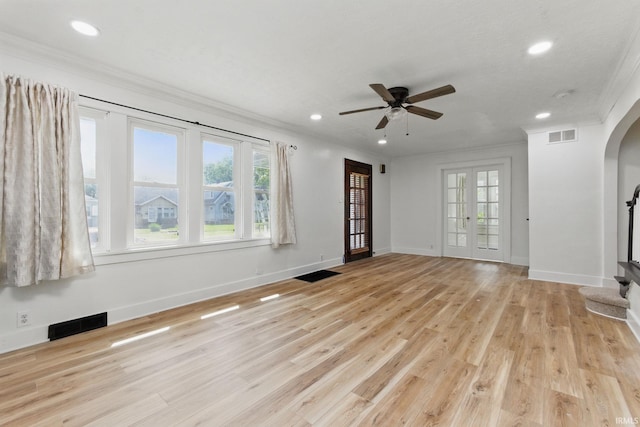 unfurnished living room with crown molding, arched walkways, recessed lighting, ceiling fan, and light wood finished floors