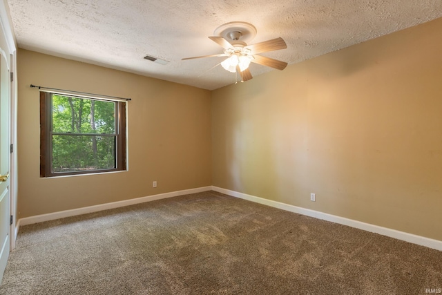 carpeted spare room with a textured ceiling, ceiling fan, and baseboards
