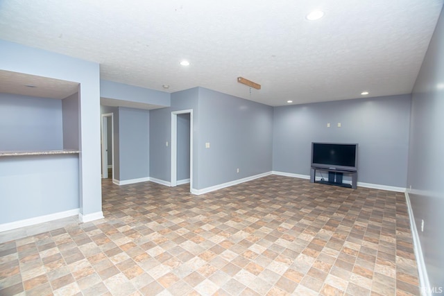 3905 Rushgrove Dr, Lafayette, IN 47909 - unfurnished living room with recessed lighting, light stone finish flooring, a textured ceiling, and baseboards