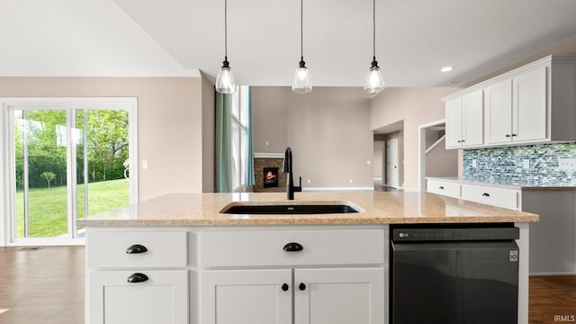 5937 Liam Ln, Fort Wayne, IN 46818 - kitchen with a sink, dishwasher, decorative backsplash, dark wood-style flooring, and light stone counters