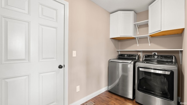 5937 Liam Ln, Fort Wayne, IN 46818 - washroom featuring cabinet space, separate washer and dryer, baseboards, and wood finished floors