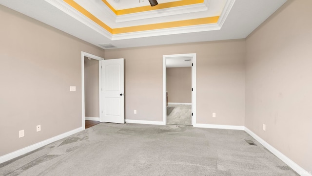 5937 Liam Ln, Fort Wayne, IN 46818 - unfurnished bedroom featuring a tray ceiling, carpet, crown molding, and baseboards