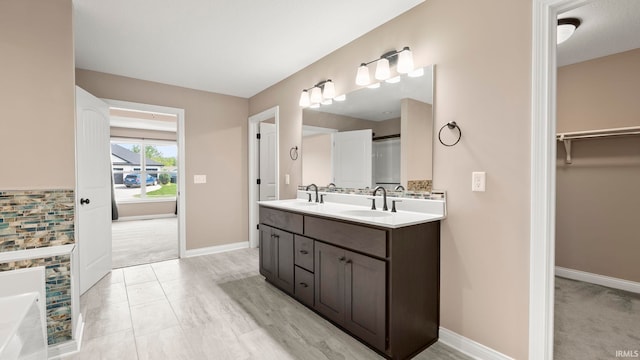 5937 Liam Ln, Fort Wayne, IN 46818 - bathroom with baseboards, double vanity, and a spacious closet