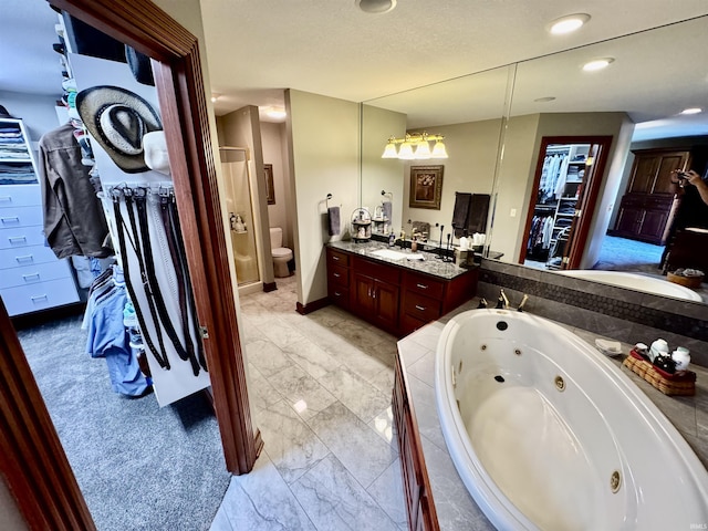 16529 State Road 1st Rd, Spencerville, IN 46788 - bathroom with marble finish flooring, a jetted tub, toilet, vanity, and recessed lighting