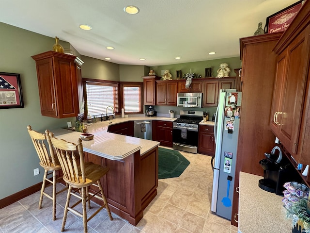 16529 State Road 1st Rd, Spencerville, IN 46788 - kitchen with appliances with stainless steel finishes, light countertops, a sink, a peninsula, and recessed lighting