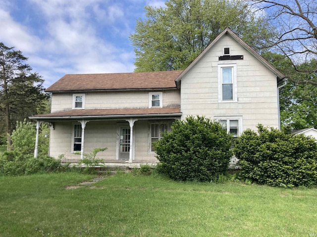 view of front of home featuring a porch, a front yard, and a shingled roof