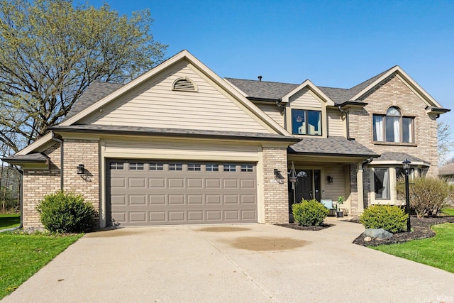 10731 Willow Creek Dr, Fort Wayne, IN 46845 - view of front of house with brick siding, concrete driveway, a garage, and a shingled roof