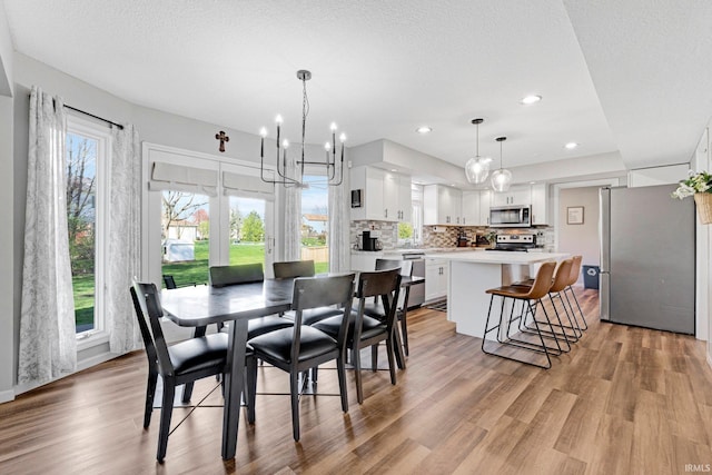 10731 Willow Creek Dr, Fort Wayne, IN 46845 - dining space with light wood-type flooring, a chandelier, and recessed lighting