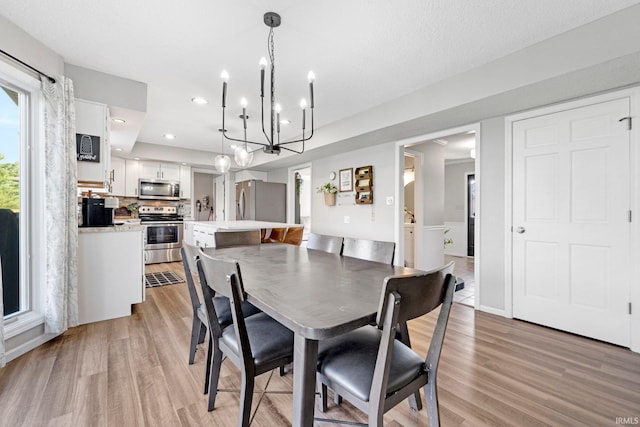 10731 Willow Creek Dr, Fort Wayne, IN 46845 - dining area featuring a chandelier, light wood-type flooring, and recessed lighting