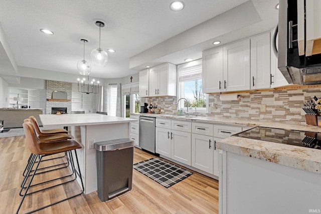 10731 Willow Creek Dr, Fort Wayne, IN 46845 - kitchen with appliances with stainless steel finishes, a sink, light countertops, white cabinets, and light wood-style flooring