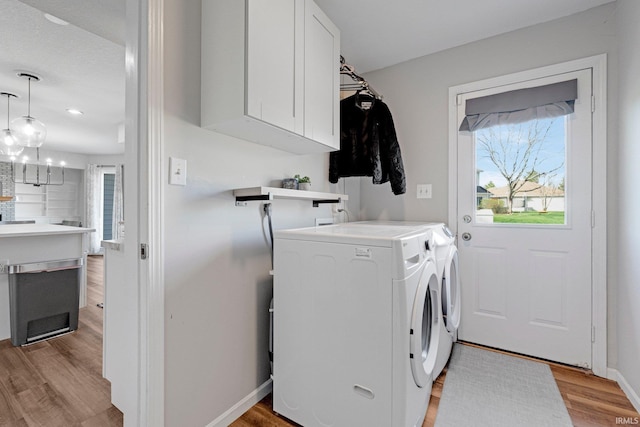 10731 Willow Creek Dr, Fort Wayne, IN 46845 - laundry room with cabinet space, light wood-style flooring, washer and dryer, and baseboards