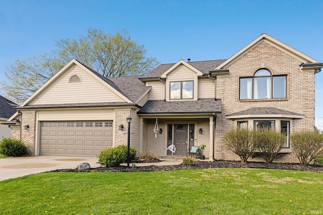 10731 Willow Creek Dr, Fort Wayne, IN 46845 - traditional-style home featuring brick siding, a front yard, a garage, driveway, and a shingled roof