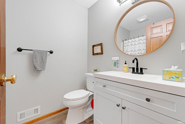 10731 Willow Creek Dr, Fort Wayne, IN 46845 - bathroom featuring wood finished floors, vanity, toilet, and baseboards