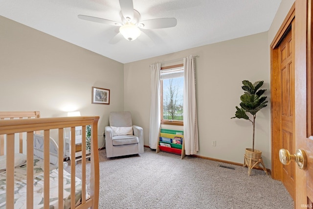 10731 Willow Creek Dr, Fort Wayne, IN 46845 - bedroom with light carpet, baseboards, a ceiling fan, and a crib