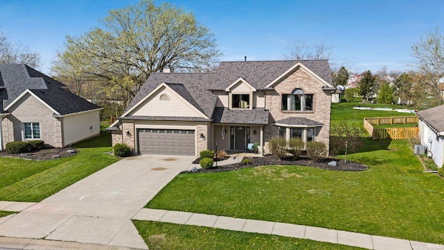 10731 Willow Creek Dr, Fort Wayne, IN 46845 - traditional-style house featuring brick siding, driveway, an attached garage, and a shingled roof