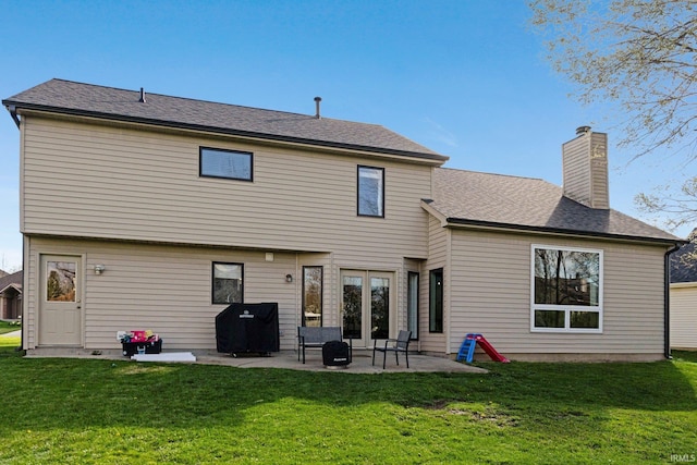 10731 Willow Creek Dr, Fort Wayne, IN 46845 - rear view of house with a patio area, a lawn, and a chimney