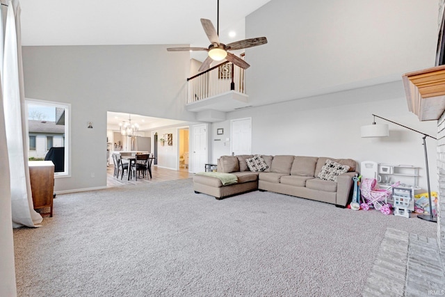 10731 Willow Creek Dr, Fort Wayne, IN 46845 - living room featuring carpet, a towering ceiling, a chandelier, ceiling fan, and baseboards