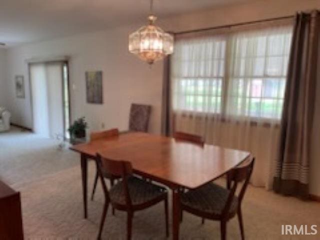 206 Pine St, Vincennes, IN 47591 - dining space featuring a chandelier and light colored carpet