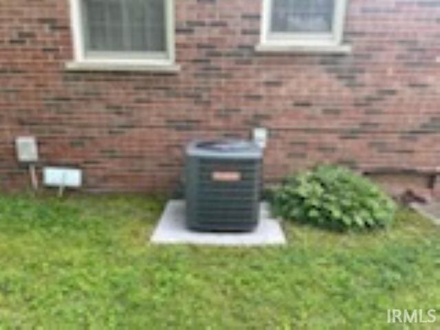 206 Pine St, Vincennes, IN 47591 - exterior view of central air condition unit, a wood stove, and brick siding