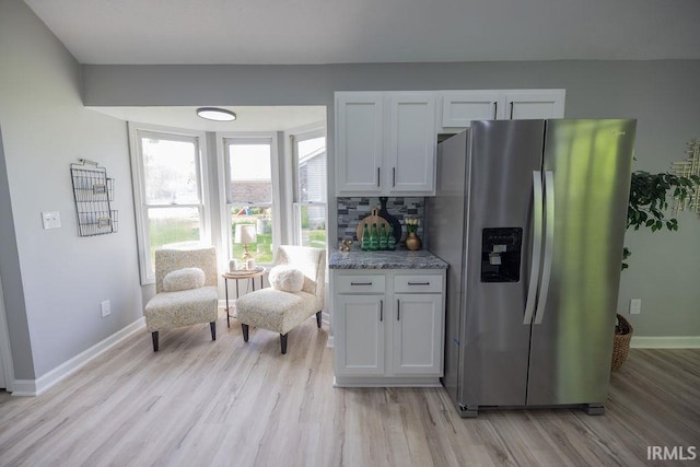 103 Bluebird Ln, Sulphur Springs, IN 47388 - kitchen with stainless steel fridge, light wood finished floors, baseboards, white cabinets, and tasteful backsplash
