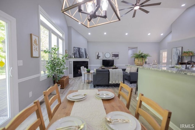 103 Bluebird Ln, Sulphur Springs, IN 47388 - dining room with high vaulted ceiling, a fireplace, wood finished floors, plenty of natural light, and recessed lighting