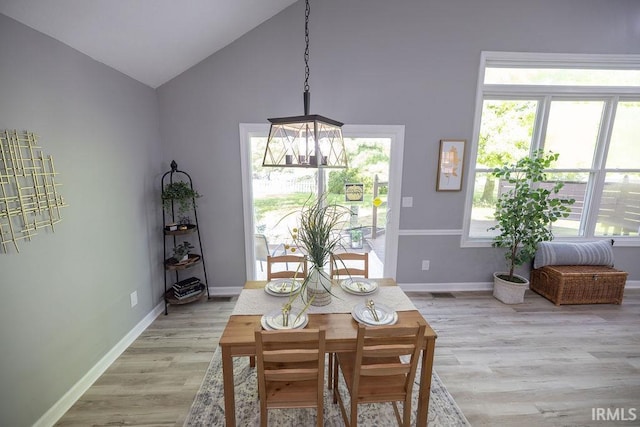 103 Bluebird Ln, Sulphur Springs, IN 47388 - dining room featuring light wood-type flooring, baseboards, and high vaulted ceiling