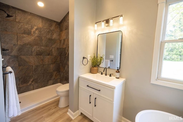 103 Bluebird Ln, Sulphur Springs, IN 47388 - bathroom with vanity, wood finished floors, tiled shower, and toilet