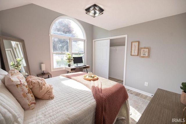 103 Bluebird Ln, Sulphur Springs, IN 47388 - bedroom with wood finished floors, vaulted ceiling, a closet, and baseboards