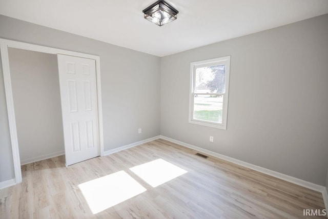 103 Bluebird Ln, Sulphur Springs, IN 47388 - unfurnished bedroom with wood finished floors, baseboards, and a closet