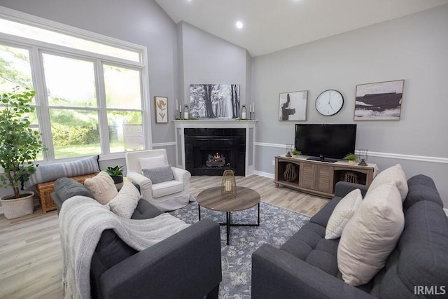 103 Bluebird Ln, Sulphur Springs, IN 47388 - living room featuring wood finished floors, a tiled fireplace, recessed lighting, and high vaulted ceiling