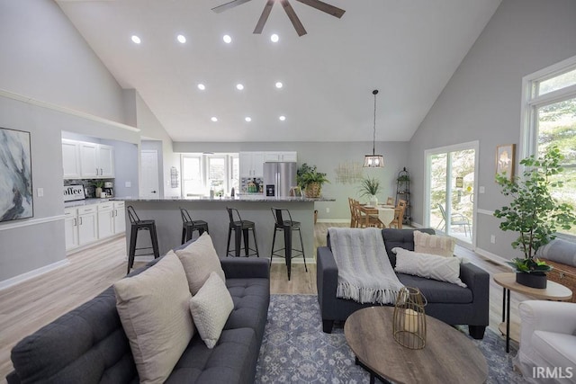 103 Bluebird Ln, Sulphur Springs, IN 47388 - living room with high vaulted ceiling, recessed lighting, a ceiling fan, light wood-type flooring, and baseboards