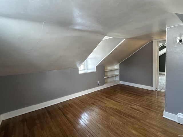 134 E 3rd St, Peru, IN 46970 - additional living space featuring baseboards, wood-type flooring, lofted ceiling, and built in features