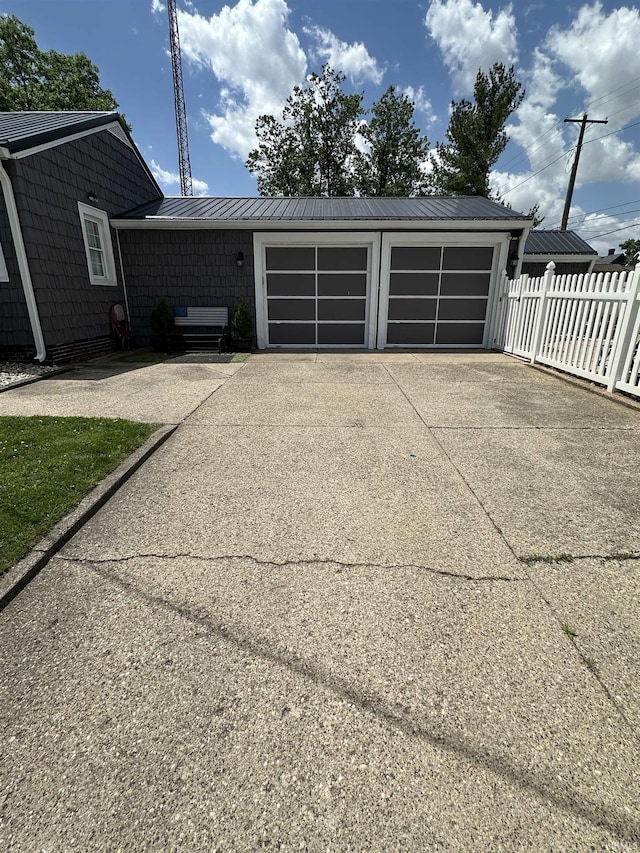 134 E 3rd St, Peru, IN 46970 - garage featuring concrete driveway and fence