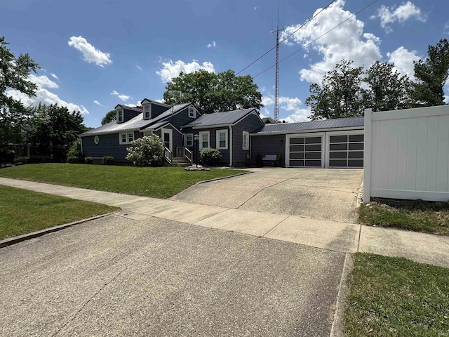 134 E 3rd St, Peru, IN 46970 - view of front facade with concrete driveway, an attached garage, and metal roof