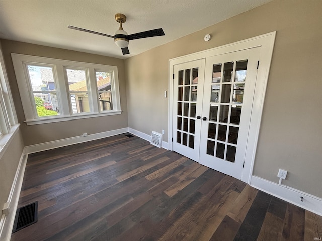 spare room featuring french doors, ceiling fan, dark wood-style floors, and baseboards