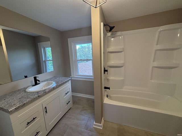 full bath with vanity, baseboards, and washtub / shower combination