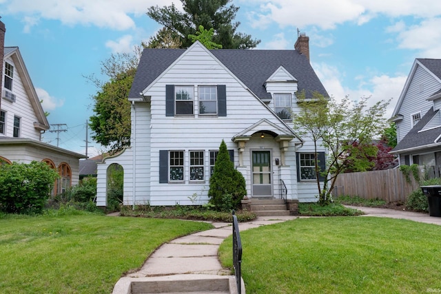 view of front of home featuring a chimney and a shingled roof