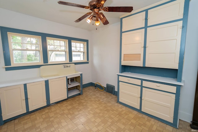 kitchen with a ceiling fan and light countertops