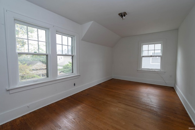 bonus room with baseboards, wood finished floors, and vaulted ceiling