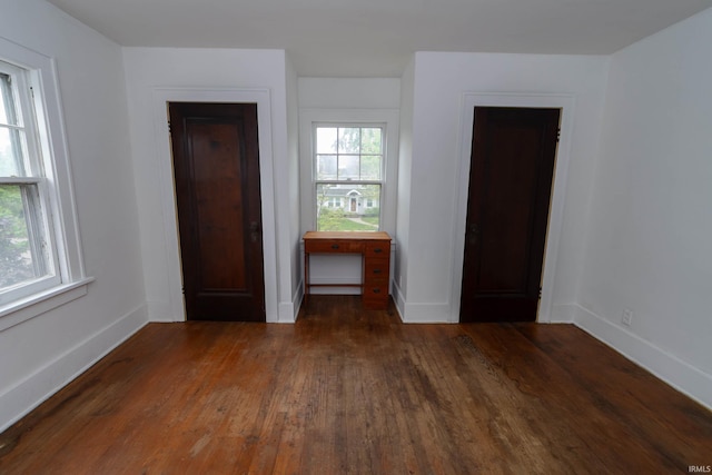 unfurnished bedroom featuring wood finished floors and baseboards