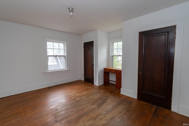 unfurnished bedroom with wood finished floors and baseboards