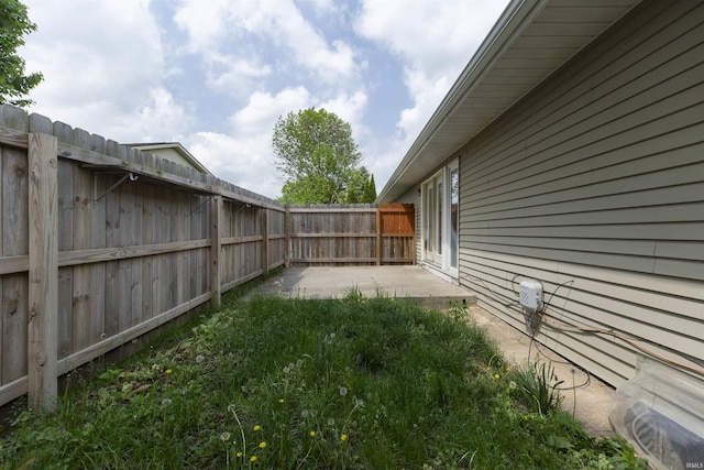 fenced backyard with a patio
